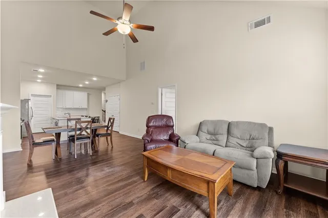 a living room with furniture and wooden floor