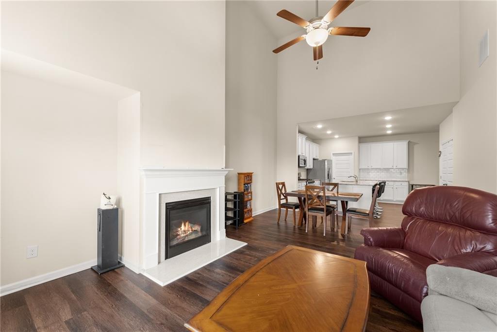 3914 Prospect Point Drive Oakwood, GA 30566 - Photo 14 of 30 a living room with furniture a fireplace and kitchen view