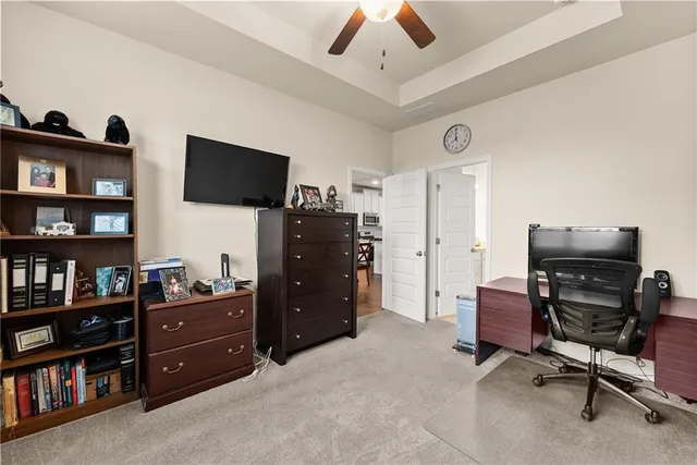 a view of a workspace with furniture and a flat screen tv