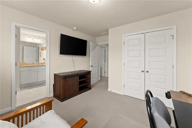 a bathroom with a granite countertop sink a toilet and shower