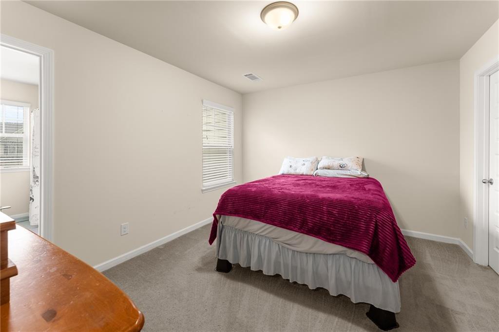 3914 Prospect Point Drive Oakwood, GA 30566 - Photo 26 of 30 a bed sitting in a room next to a window