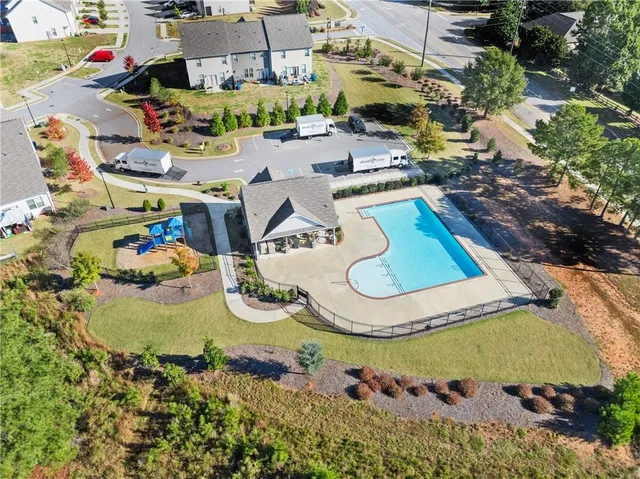 an aerial view of a house swimming pool and outdoor seating