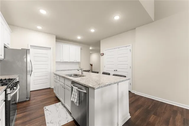 a kitchen with a sink stove and refrigerator