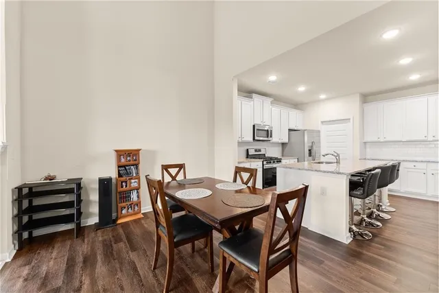 a view of a dining room with furniture and wooden floor