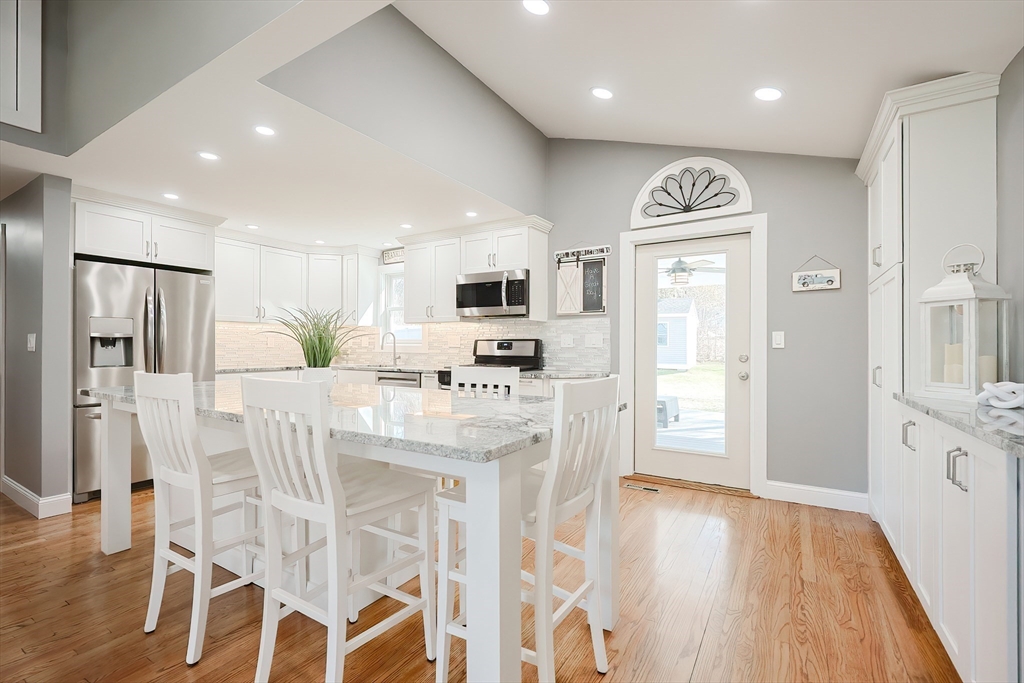 32 Anchorage Road Franklin, MA 02038 - Photo 3 of 32 a kitchen with stainless steel appliances kitchen island granite countertop a refrigerator and microwave