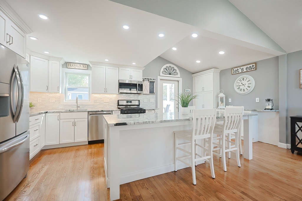 32 Anchorage Road Franklin, MA 02038 - Photo 4 of 32 a kitchen with white cabinets and stainless steel appliances