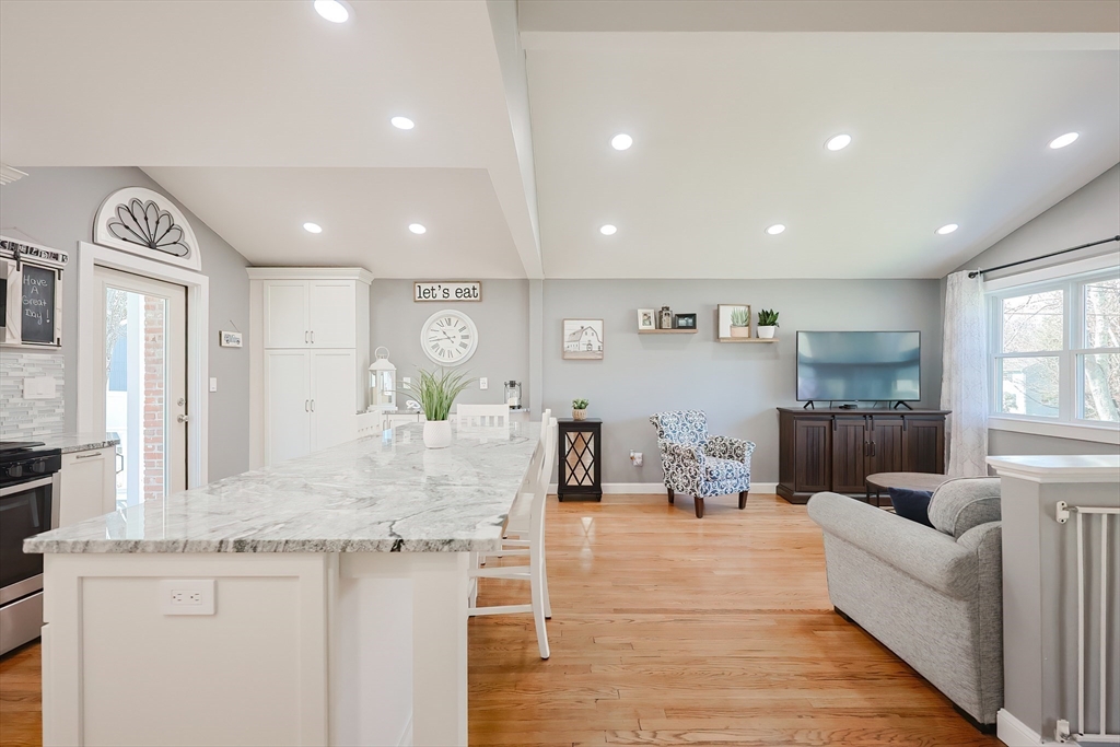 32 Anchorage Road Franklin, MA 02038 - Photo 5 of 32 a living room with kitchen island furniture and a wooden floor