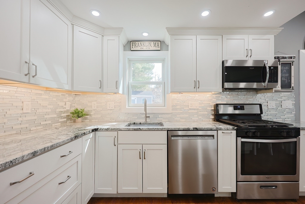 32 Anchorage Road Franklin, MA 02038 - Photo 7 of 32 a kitchen with granite countertop white cabinets and stainless steel appliances
