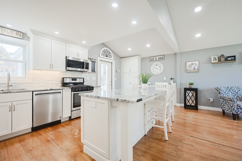 32 Anchorage Road Franklin, MA 02038 - Photo 8 of 32 a kitchen with stainless steel appliances kitchen island granite countertop a refrigerator oven a sink dishwasher and white cabinets with wooden floor