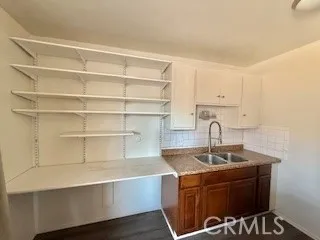 a view of a kitchen with a sink stainless steel appliances and cabinets
