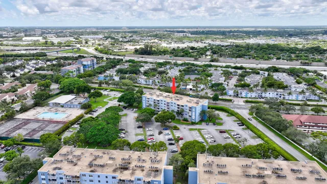 an aerial view of a city with lots of residential buildings lake and ocean view