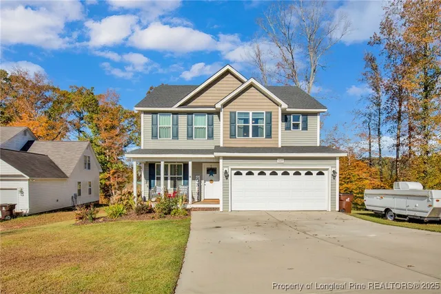 a front view of a house with a yard and garage