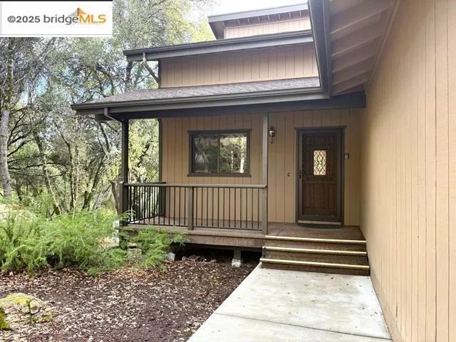 a view of a house with a wooden fence