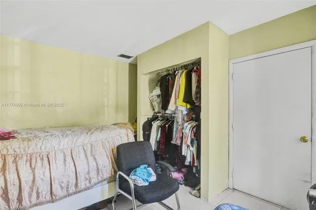 a bedroom with a bed and a mirror