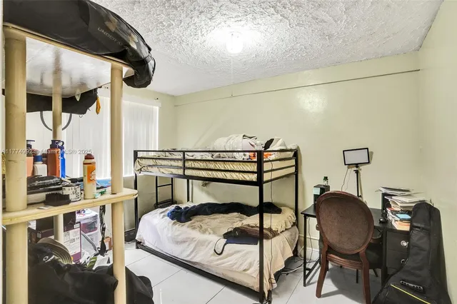 a bedroom with a bed and a chair