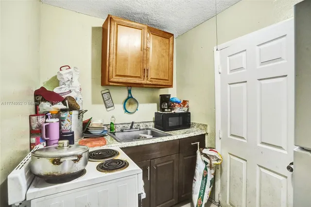 a kitchen with a sink stove and cabinets