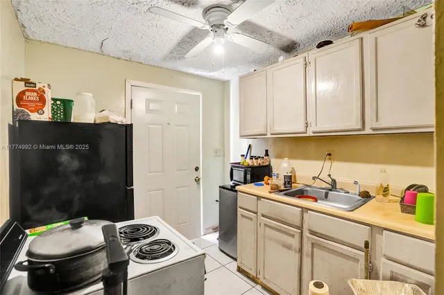 a kitchen with a sink appliances and cabinets