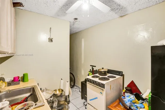 a white kitchen with a stove and a refrigerator