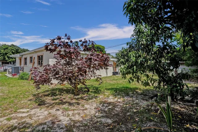 a view of a house with a tree in the background