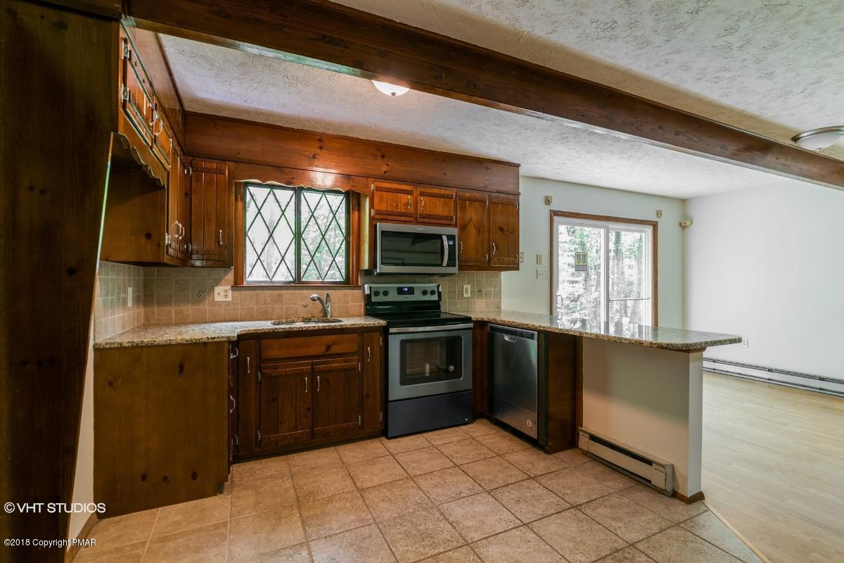 1186 Little Twig Road Effort, PA 18330 - Photo 12 of 24 a kitchen with stainless steel appliances granite countertop a stove a sink and a microwave