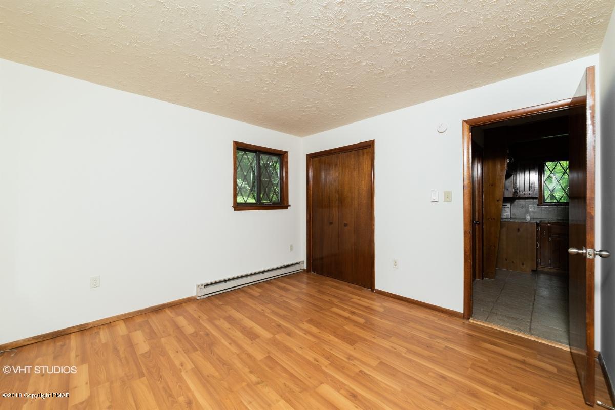 1186 Little Twig Road Effort, PA 18330 - Photo 18 of 24 an empty room with wooden floor and windows