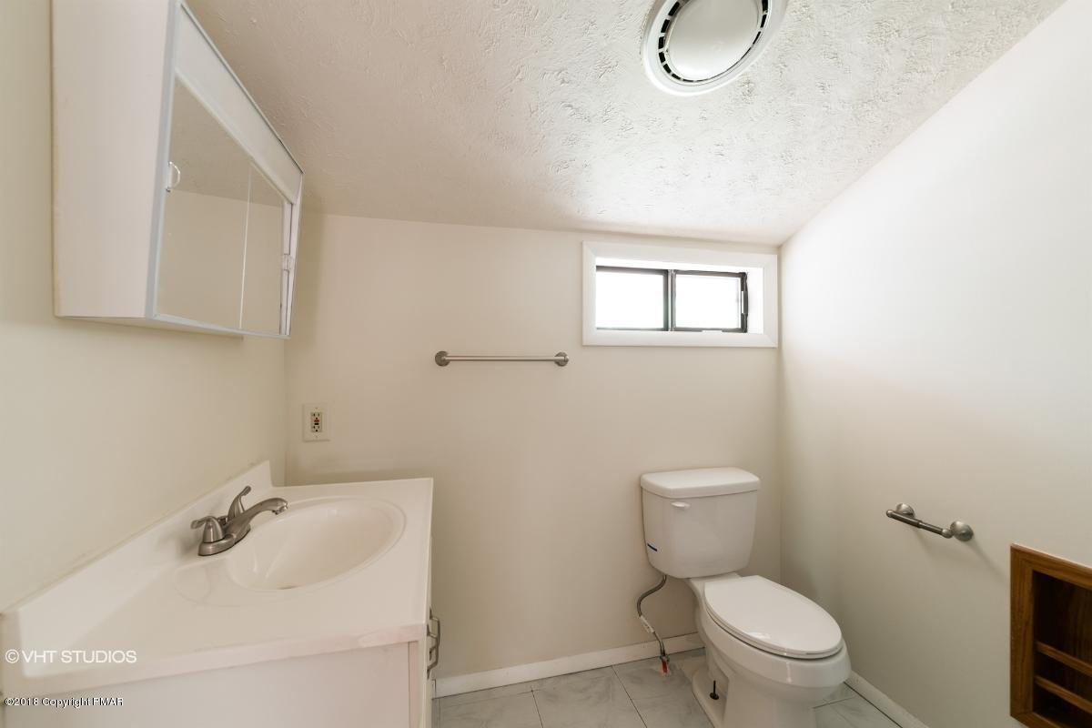 1186 Little Twig Road Effort, PA 18330 - Photo 22 of 24 a bathroom with a sink a toilet and a mirror