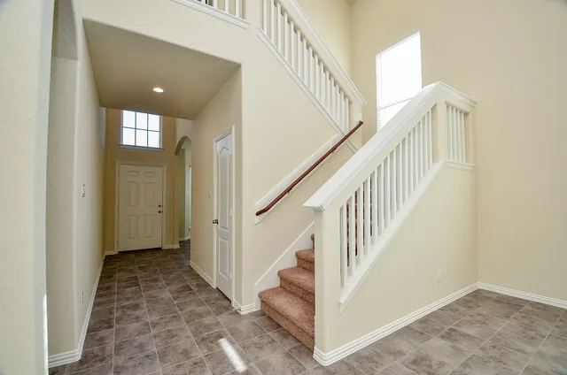 a kitchen with granite countertop stainless steel appliances a refrigerator stove top oven and granite counter tops