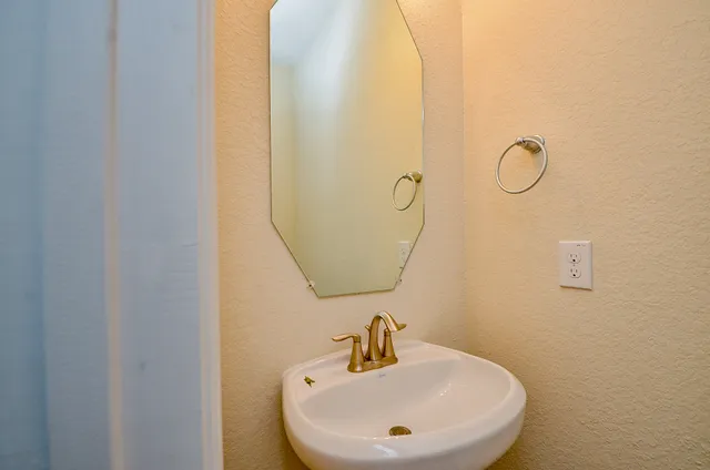 a kitchen with a refrigerator sink and cabinets