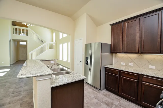 a kitchen with a sink stove and microwave