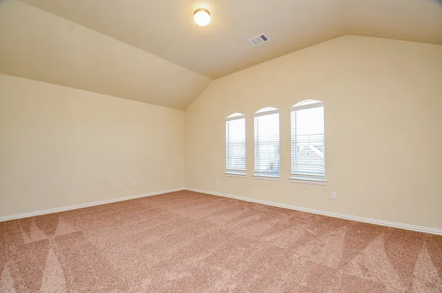 an empty room with windows and entrance