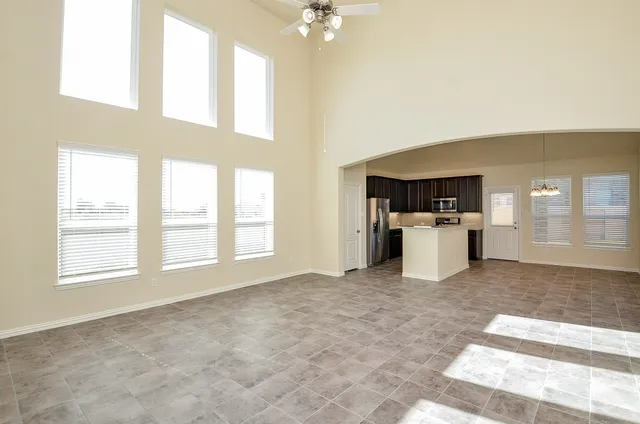 a view of staircase with lots of frames on wall and a view of entryway