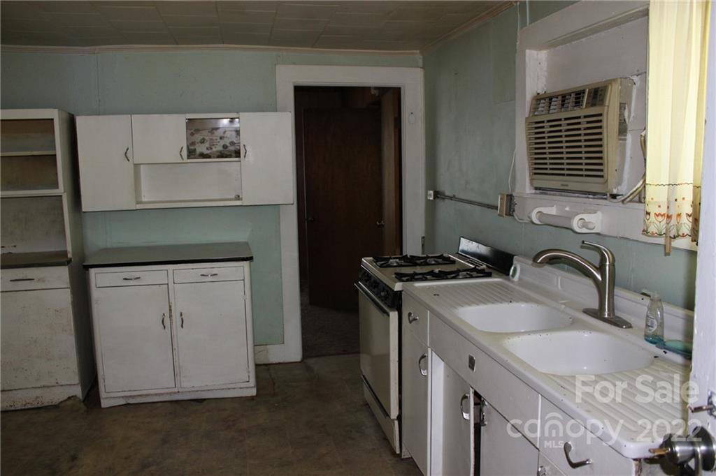 530 Edwards St Extension Rutherfordton, NC 28139 - Photo 20 of 48 a kitchen with granite countertop a sink stove and cabinets