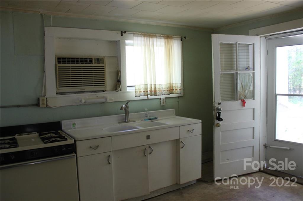 530 Edwards St Extension Rutherfordton, NC 28139 - Photo 21 of 48 a kitchen with a sink stove and cabinets