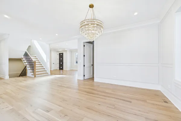 a view of empty room with wooden floor and fireplace