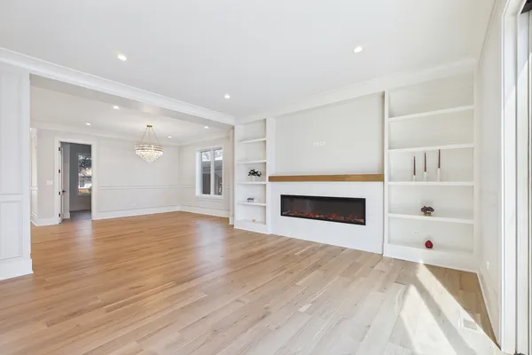a large kitchen with stainless steel appliances kitchen island a large counter top and a wooden floors