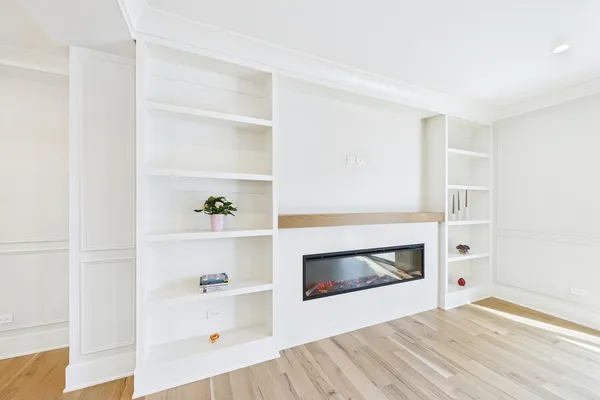 a view of a kitchen with kitchen island a sink dishwasher and a refrigerator with wooden floor