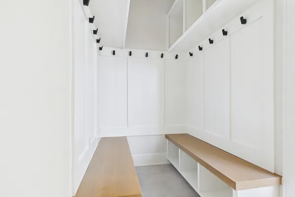 a view of an empty room with wooden floor and window