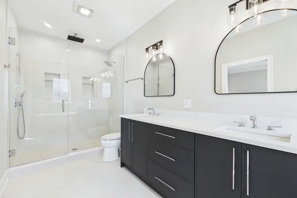 a bathroom with a sink a toilet and shower