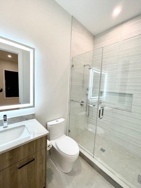 246 Forest Street Needham, MA 02492 - Photo 20 of 32 a bathroom with a toilet a sink and shower