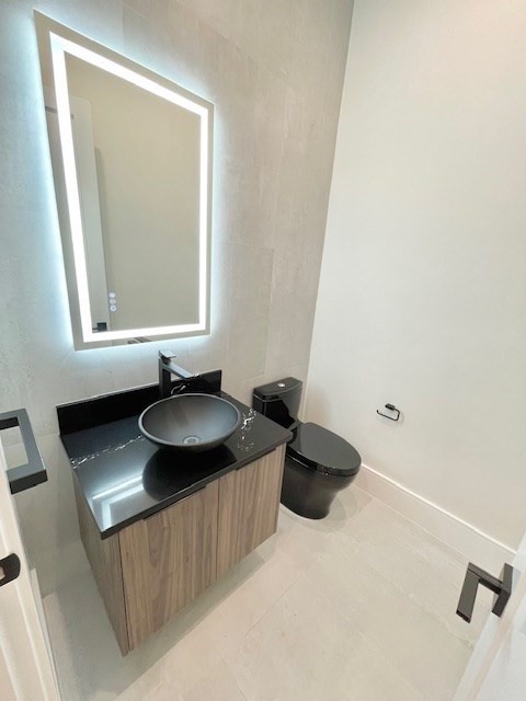 246 Forest Street Needham, MA 02492 - Photo 10 of 32 a bathroom with a sink and a mirror