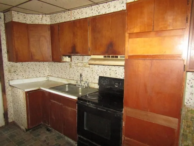 a kitchen with a sink and a refrigerator
