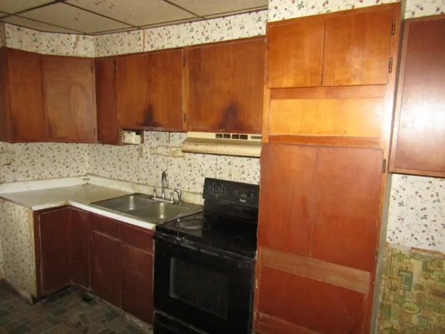 a kitchen with a sink and a refrigerator