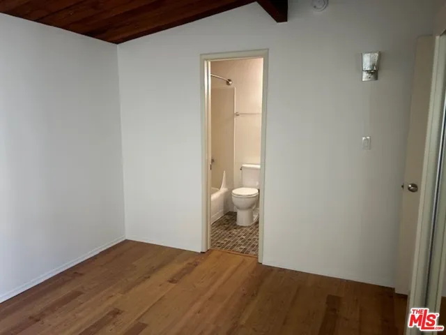 a white toilet sitting next to a bath tub