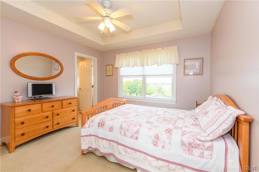 577 Lefevre Road Easton, PA 18040 - Photo 17 of 30 a bedroom with a bed and a chandelier
