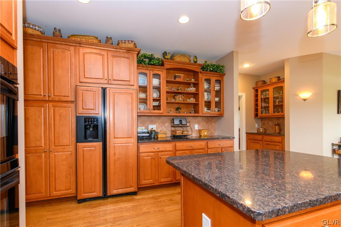577 Lefevre Road Easton, PA 18040 - Photo 8 of 30 a kitchen with stainless steel appliances granite countertop a refrigerator a stove and a sink with wooden cabinets