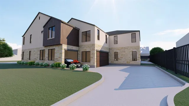 a front view of a house with a garden and yard