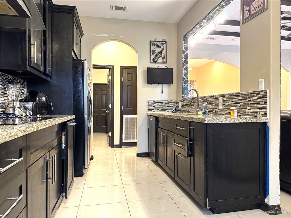 6105 South Mars Lane Pharr, TX 78577 - Photo 25 of 45 a kitchen with stainless steel appliances granite countertop a stove a sink and a refrigerator