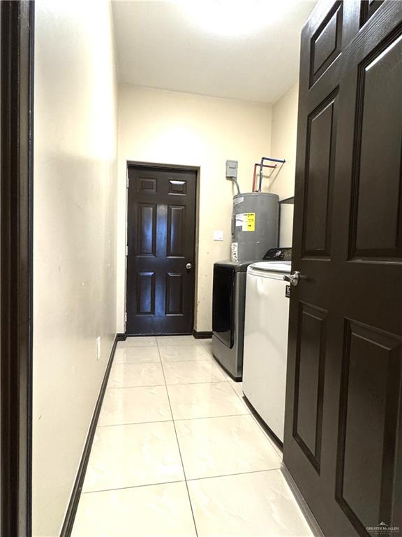 6105 South Mars Lane Pharr, TX 78577 - Photo 26 of 45 a kitchen with a refrigerator and washer