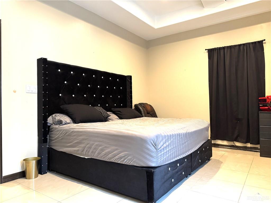 6105 South Mars Lane Pharr, TX 78577 - Photo 27 of 45 a bedroom with a bed and cabinets