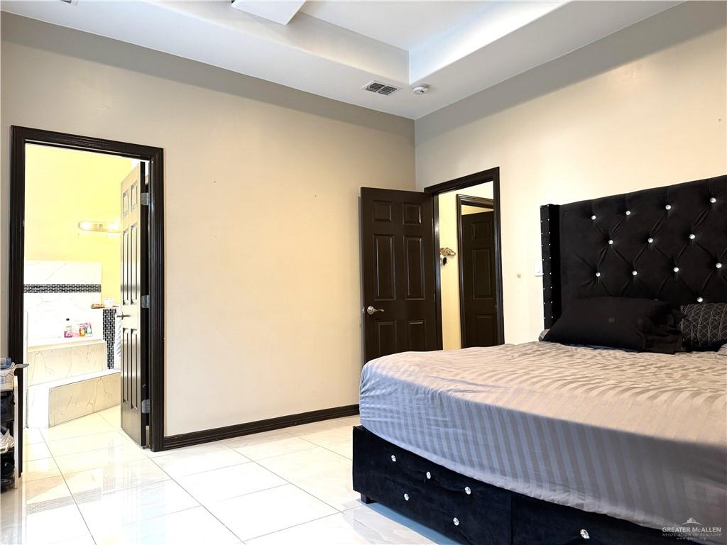 6105 South Mars Lane Pharr, TX 78577 - Photo 28 of 45 a bedroom with a bed and a dresser